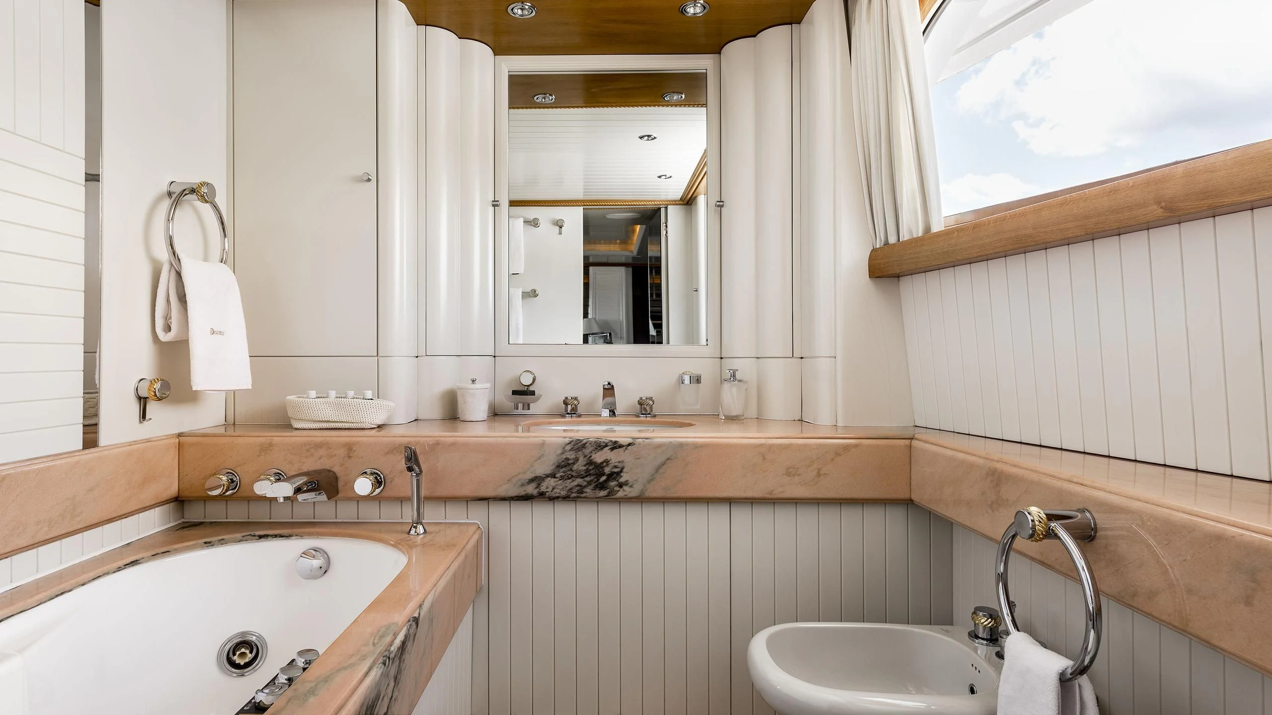 a bathroom with a sink and a mirror aboard DESAMIS B Yacht for Sale