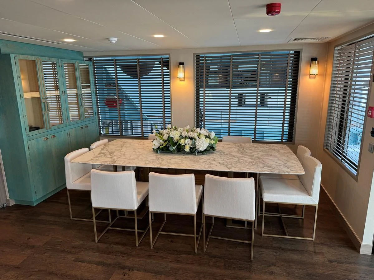 a table with chairs around it aboard FIVE OCEANS Yacht for Sale