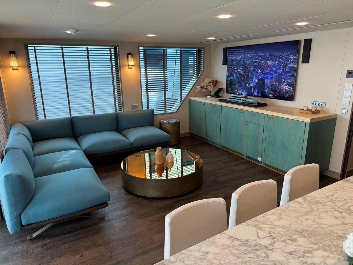 a living room with a table and chairs aboard FIVE OCEANS Yacht for Sale
