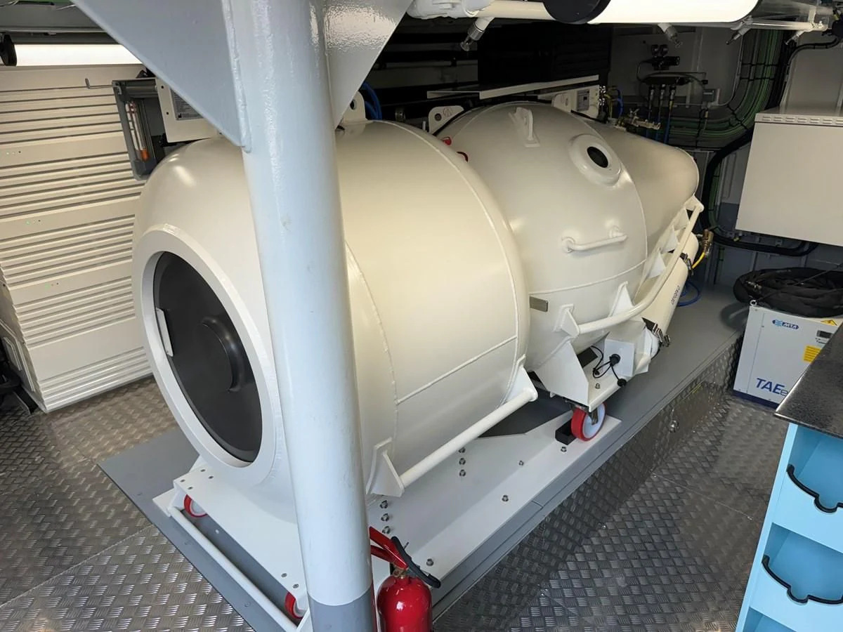 a large machine with a large piece of equipment on the side aboard FIVE OCEANS Yacht for Sale