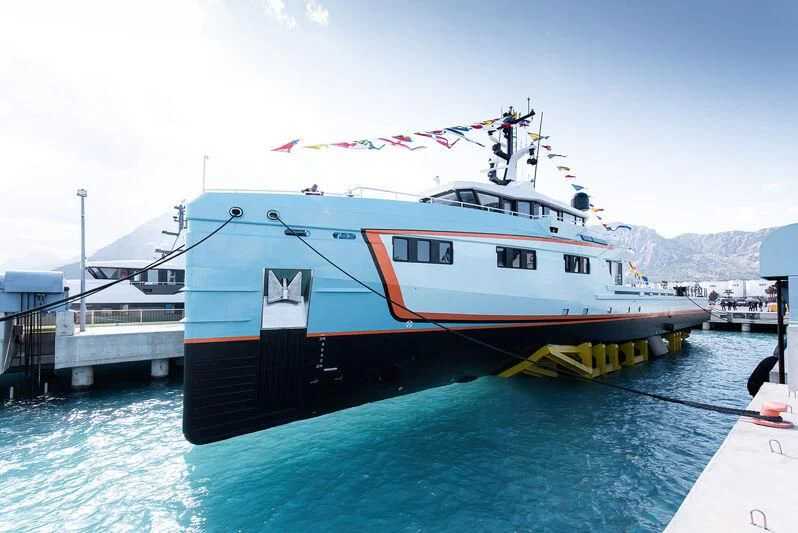 a large ship docked at a pier aboard FIVE OCEANS Yacht for Sale