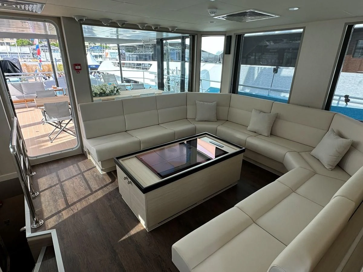 a living room with a couch and a coffee table aboard FIVE OCEANS Yacht for Sale