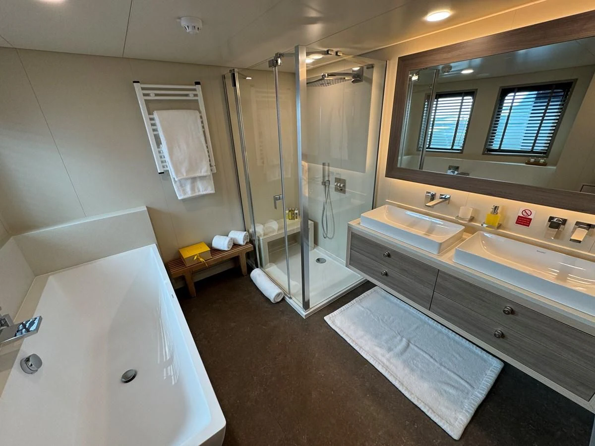 a bathroom with a shower and sink aboard FIVE OCEANS Yacht for Sale