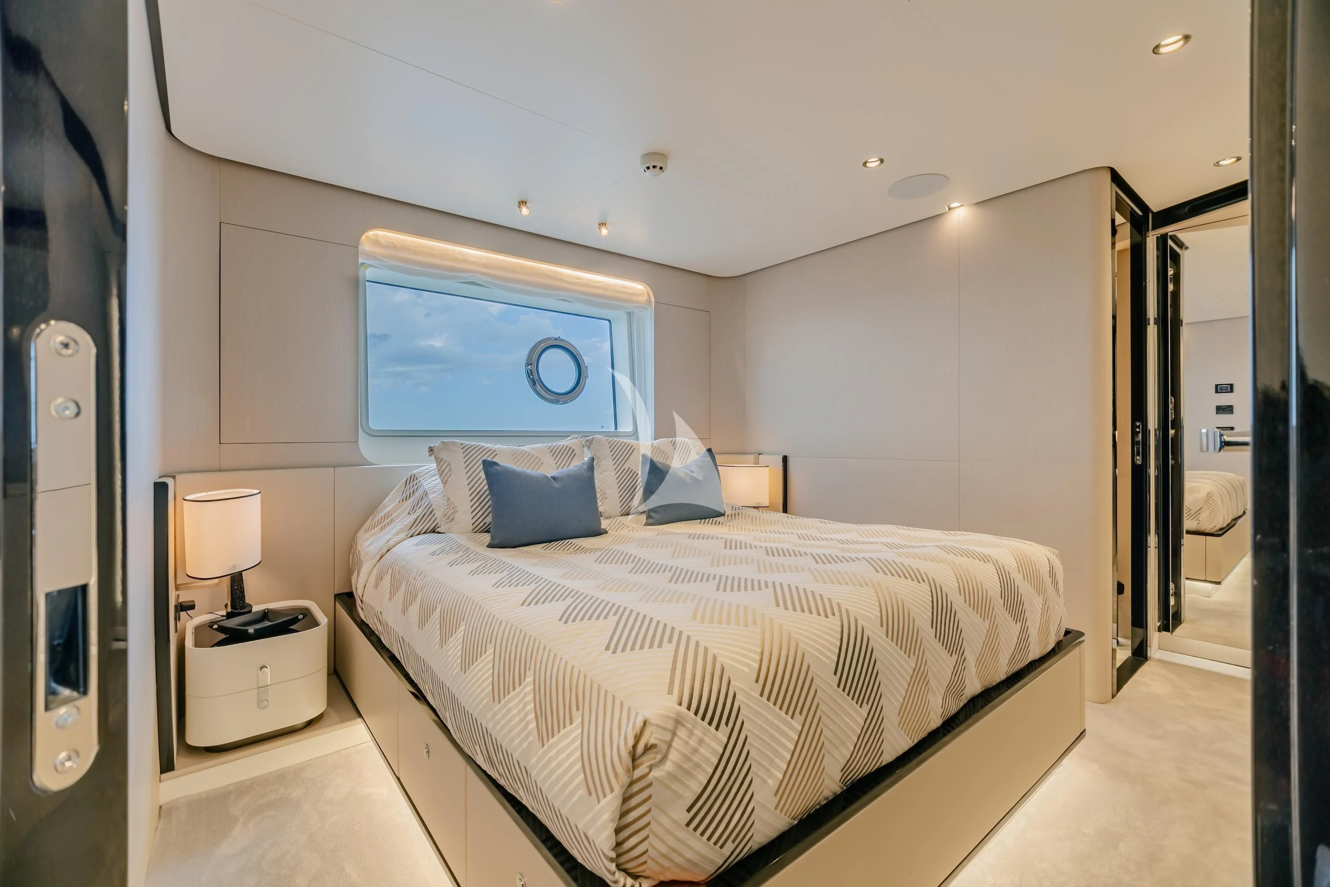 a bedroom with a bed and a lamp aboard MAREA LA NAUTICA Yacht for Sale