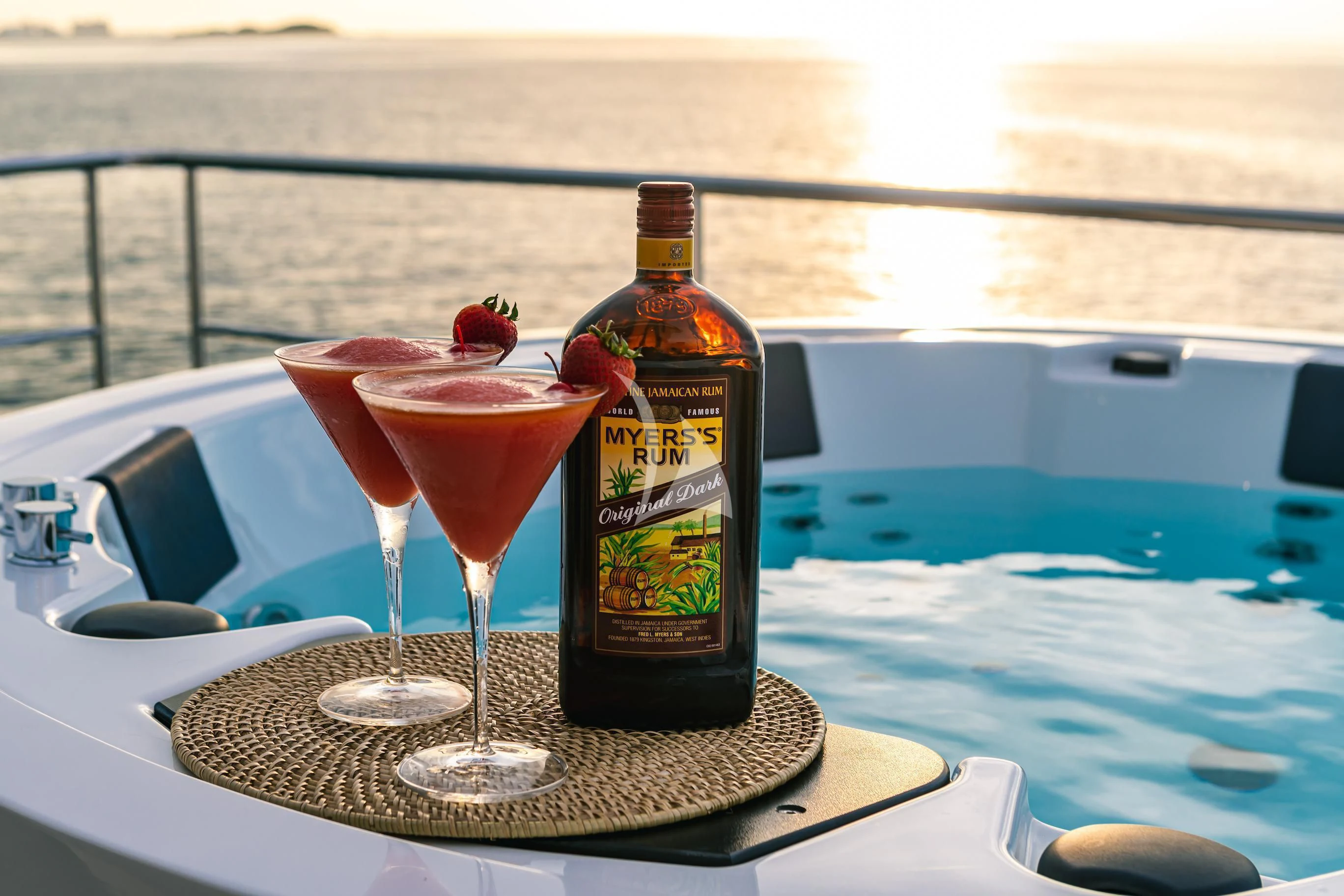 a bottle of beer and a glass of red wine on a table aboard MAREA LA NAUTICA Yacht for Sale