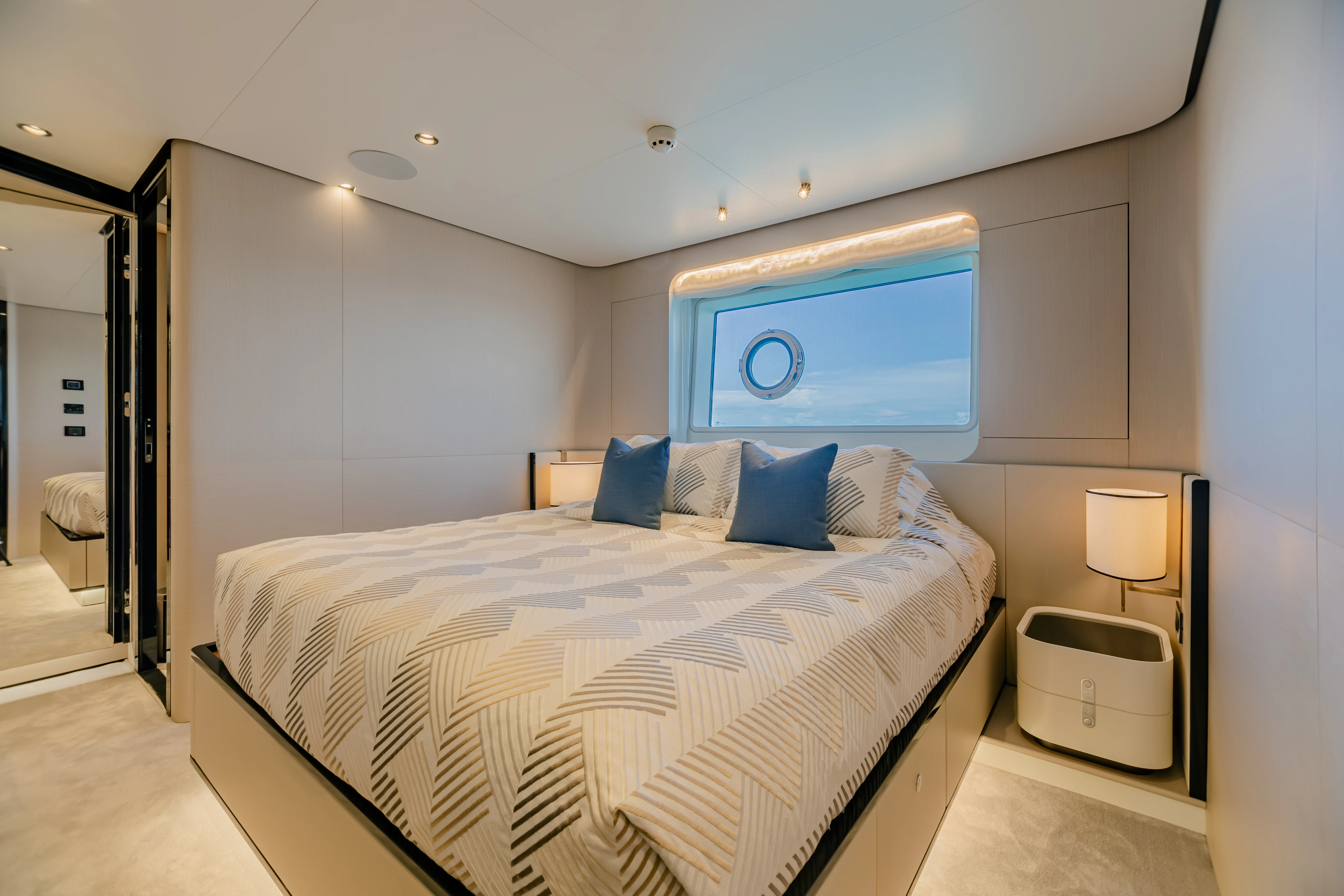 a bedroom with a bed and a mirror aboard MAREA LA NAUTICA Yacht for Sale