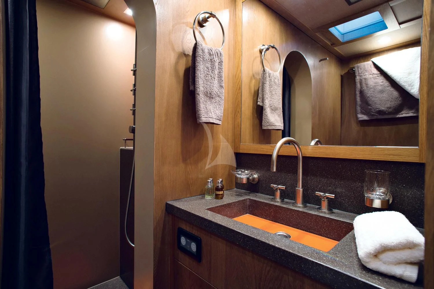 a bathroom with a sink and towels aboard MASHUA BLUU Yacht for Sale