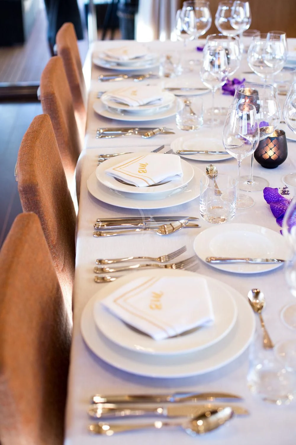 a table with plates and silverware aboard MASHUA BLUU Yacht for Sale