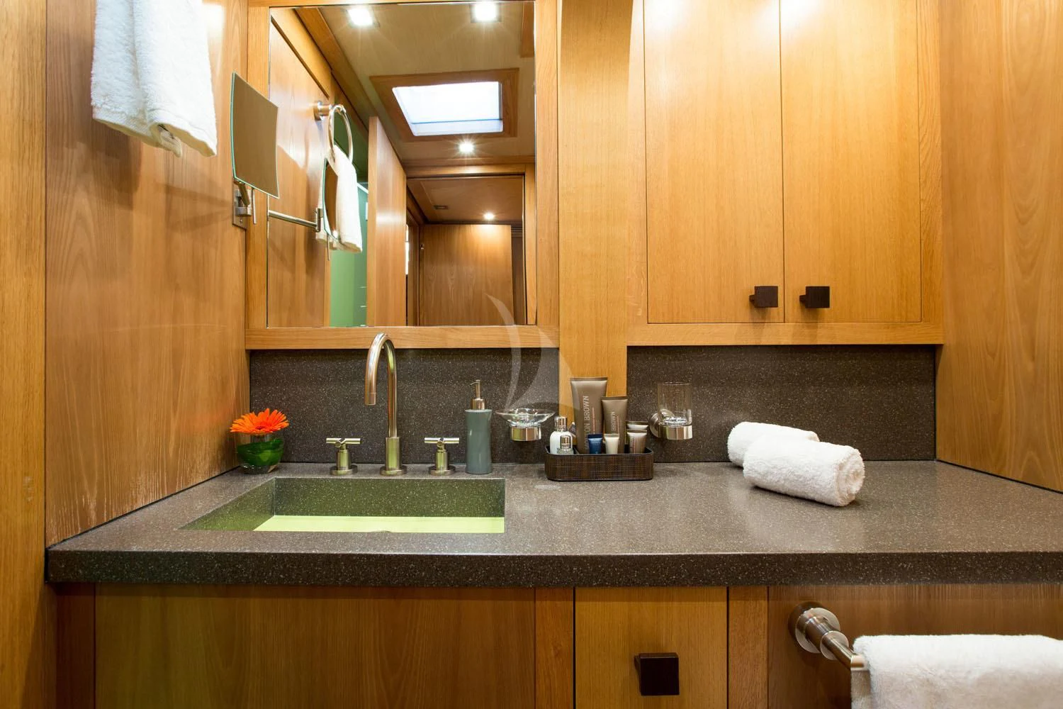 a kitchen with wooden cabinets aboard MASHUA BLUU Yacht for Sale