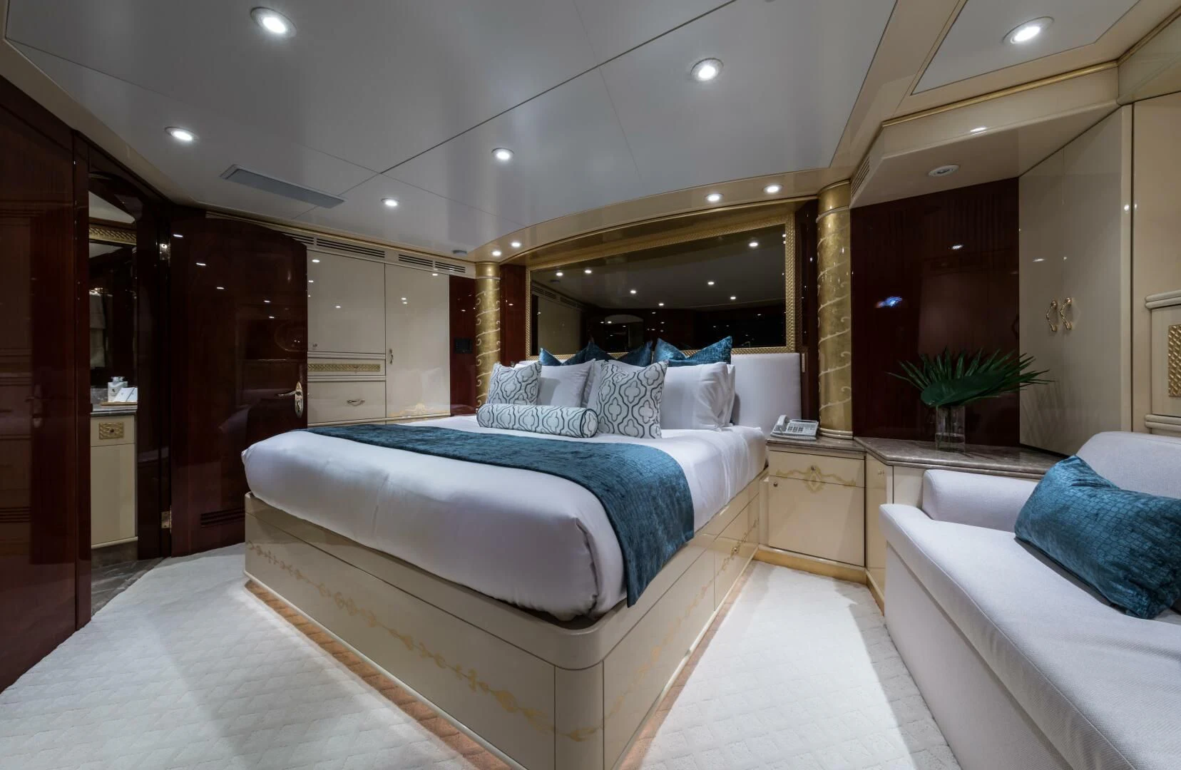 a room with a bed and a mirror aboard TOUCH Yacht for Sale