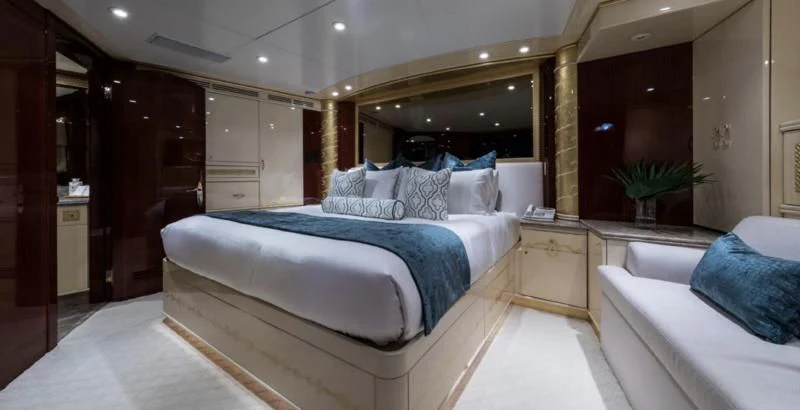 a room with a bed and a mirror aboard TOUCH Yacht for Sale
