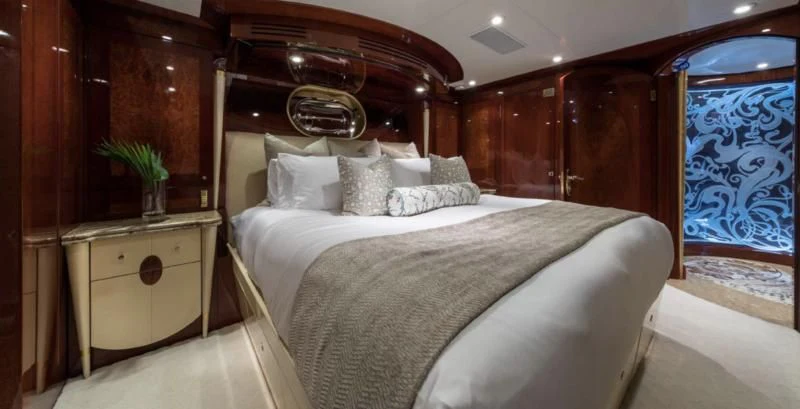 a bed with a white bed spread aboard TOUCH Yacht for Sale