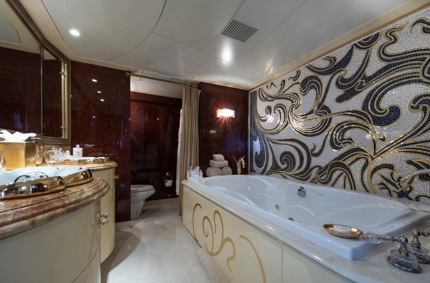 a bathroom with a bathtub and sinks aboard TOUCH Yacht for Sale