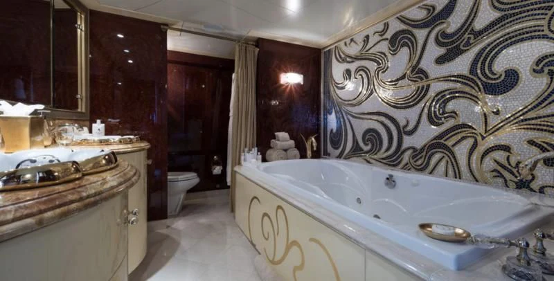 a bathroom with a bathtub sink and toilet aboard TOUCH Yacht for Sale