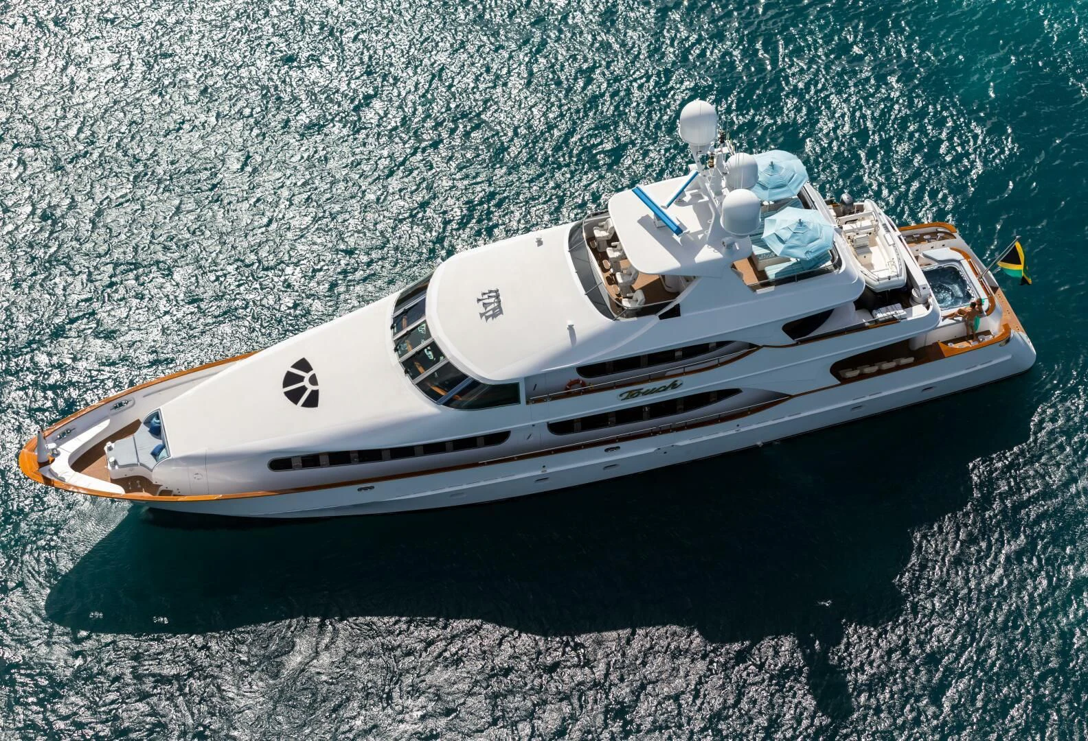 a white sports car on a dirt road aboard TOUCH Yacht for Sale