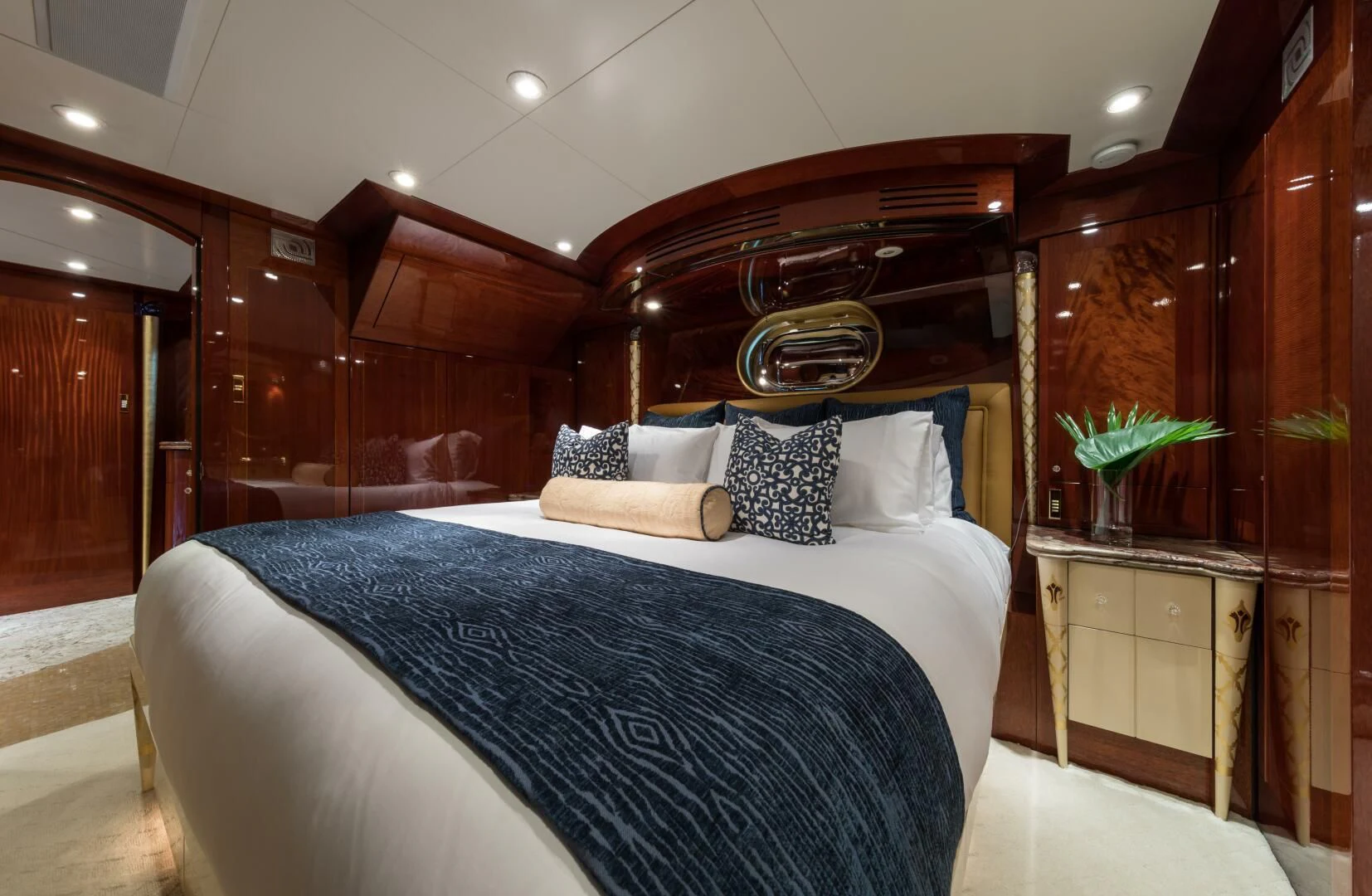 a bed with a blue comforter aboard TOUCH Yacht for Sale