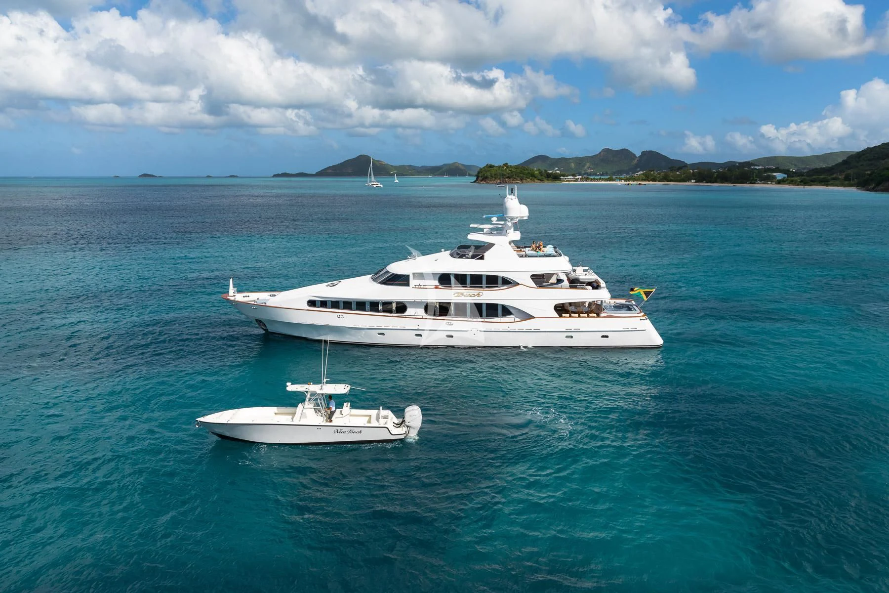 a couple of white yachts in the water aboard TOUCH Yacht for Sale