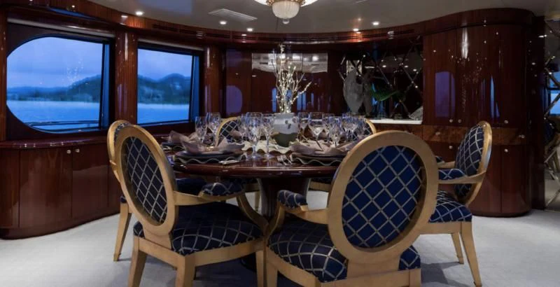 a room with a table and chairs aboard TOUCH Yacht for Sale