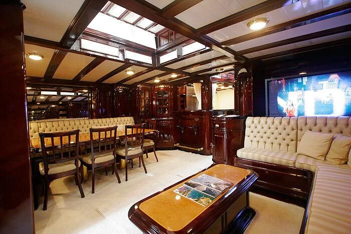 a room with a table and chairs aboard ATREVIDA Yacht for Sale