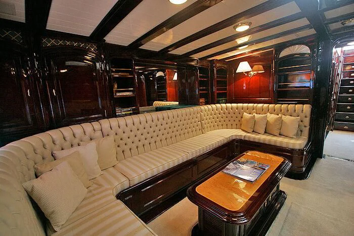 a living room with a couch and a coffee table aboard ATREVIDA Yacht for Sale