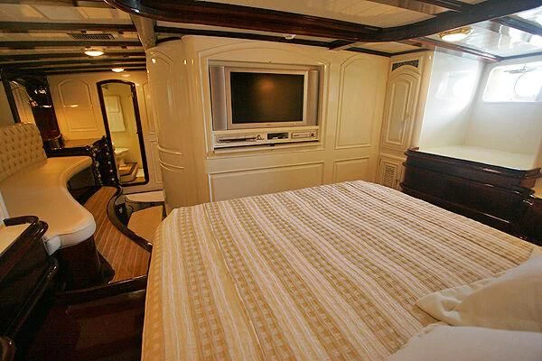 a bedroom with a tv and a bed aboard ATREVIDA Yacht for Sale