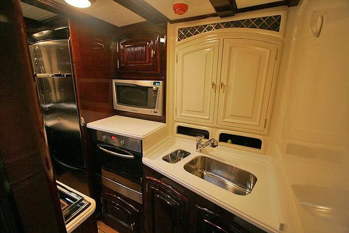 a kitchen with a sink and microwave aboard ATREVIDA Yacht for Sale