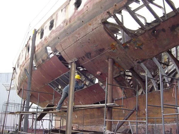 a person working on a large steel structure aboard ATREVIDA Yacht for Sale