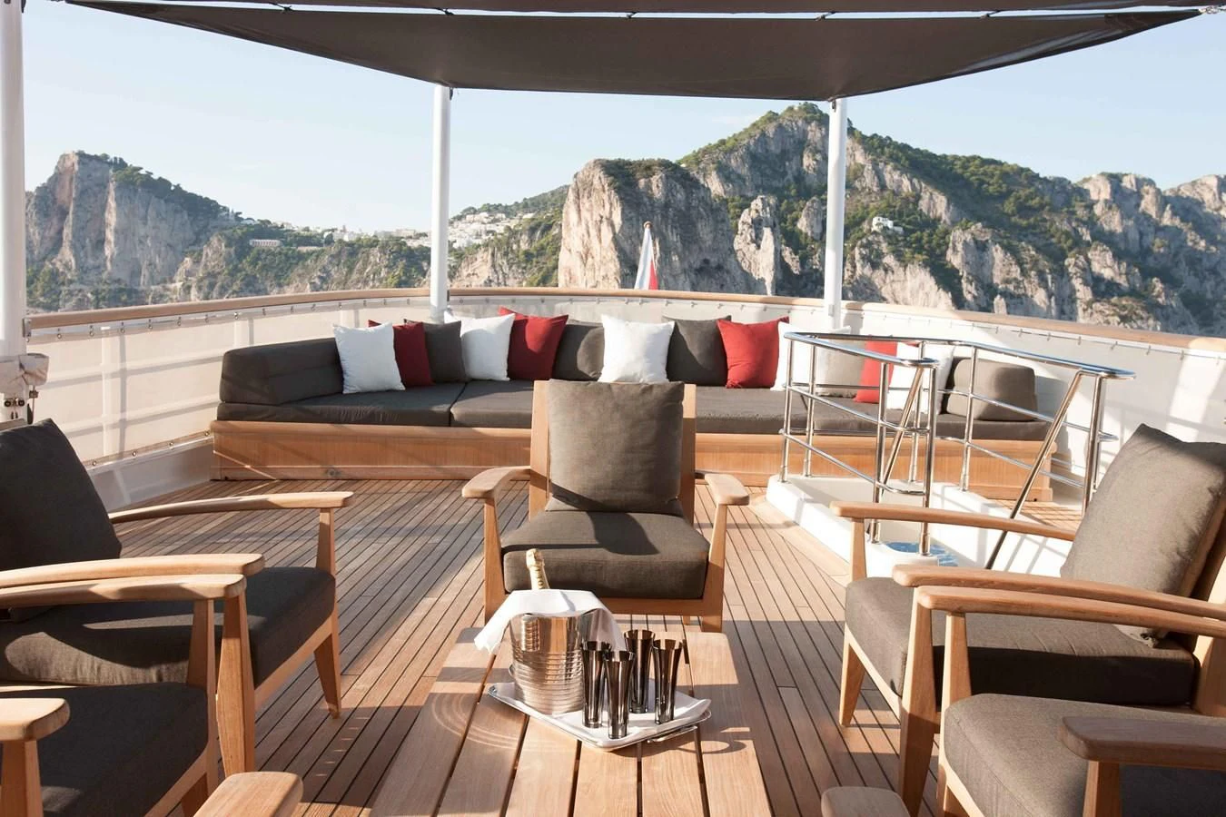 a deck with a view of mountains and trees aboard ICE LADY Yacht for Sale