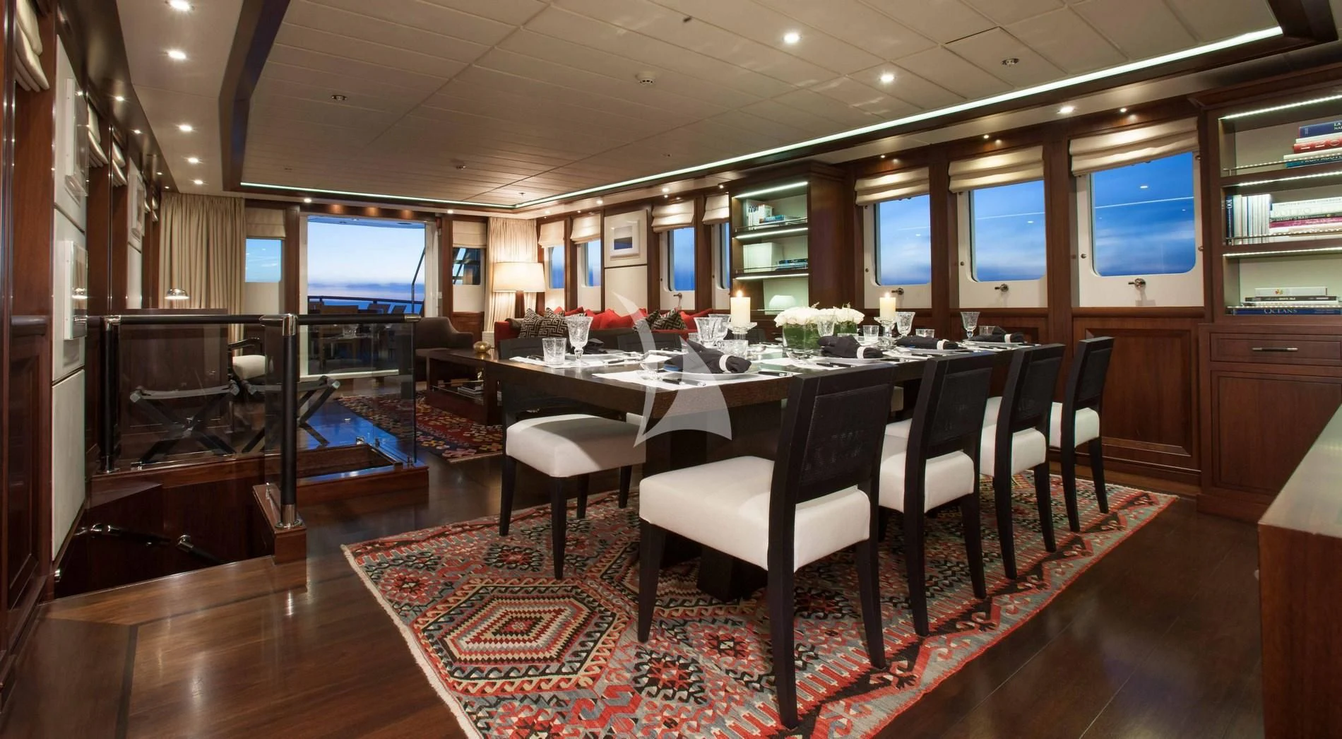 a large room with a table and chairs aboard ICE LADY Yacht for Sale