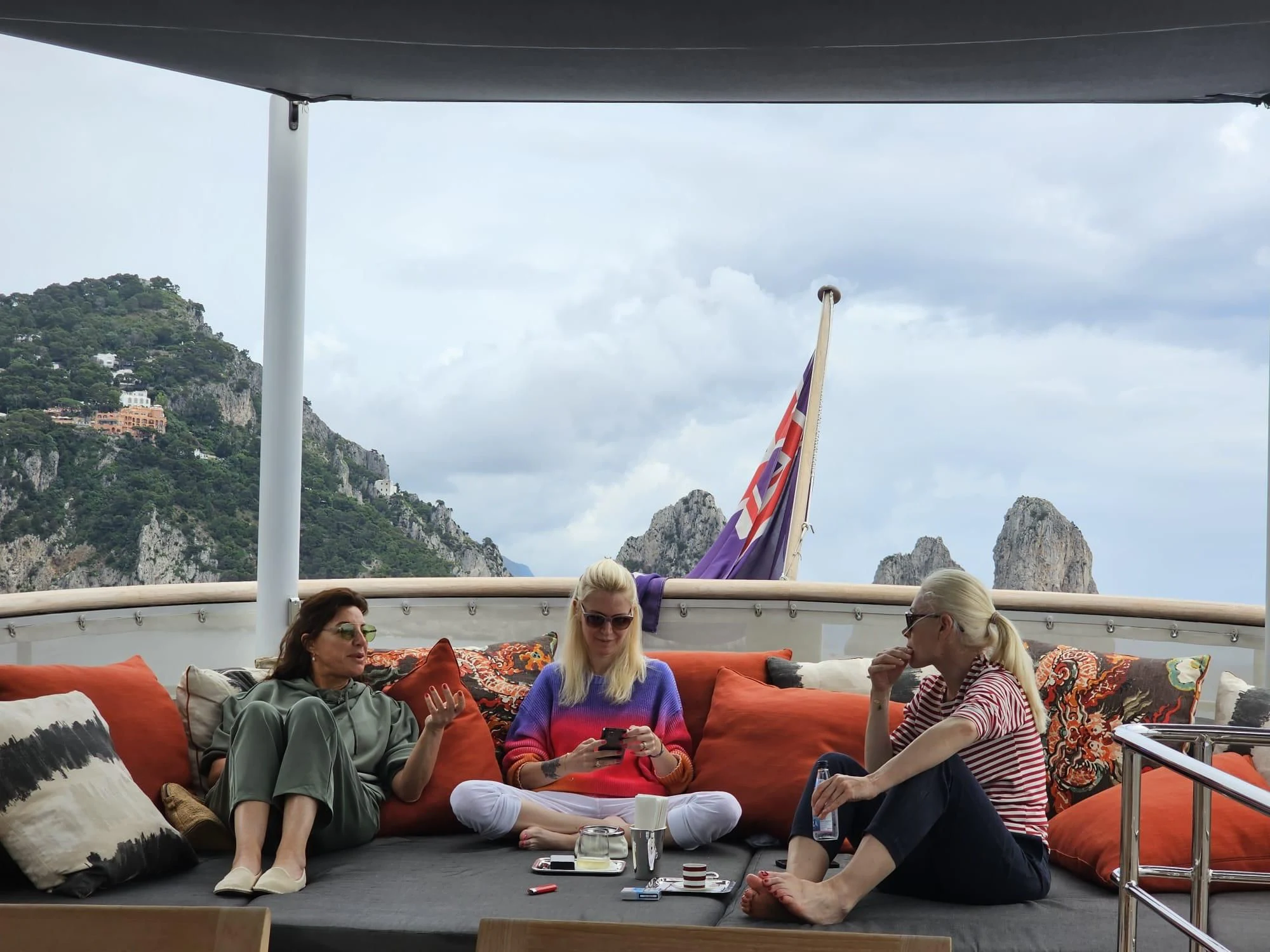 a group of women sitting on a couch aboard ICE LADY Yacht for Sale