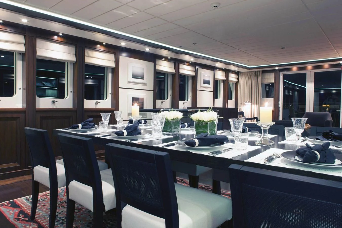a table with many glasses and plates on it aboard ICE LADY Yacht for Sale