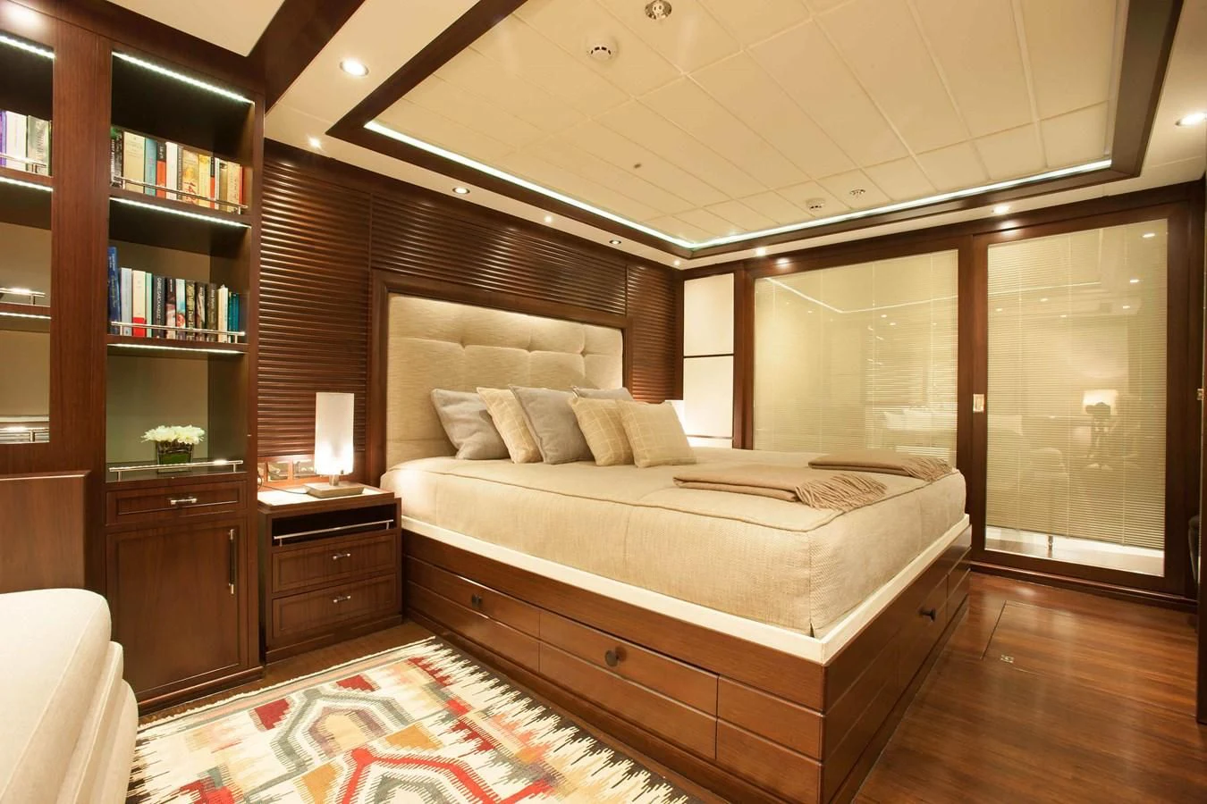 a room with a bed and a bookcase aboard ICE LADY Yacht for Sale