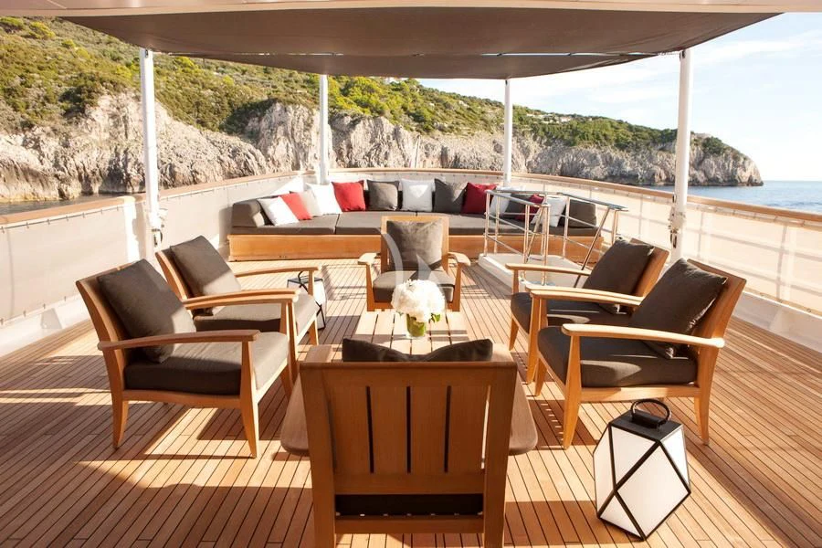 a deck with chairs and tables aboard ICE LADY Yacht for Sale