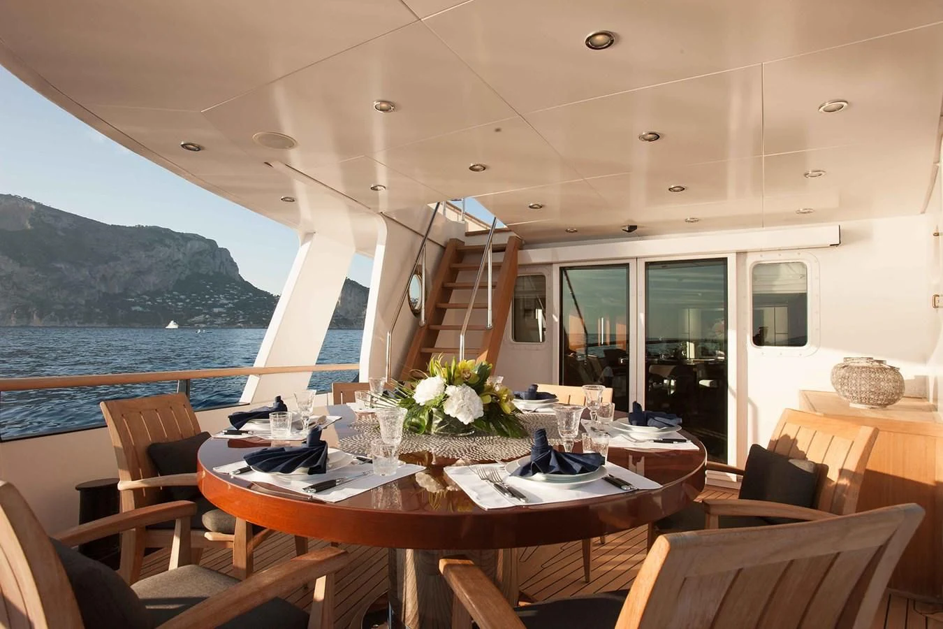 a room with tables and chairs aboard ICE LADY Yacht for Sale