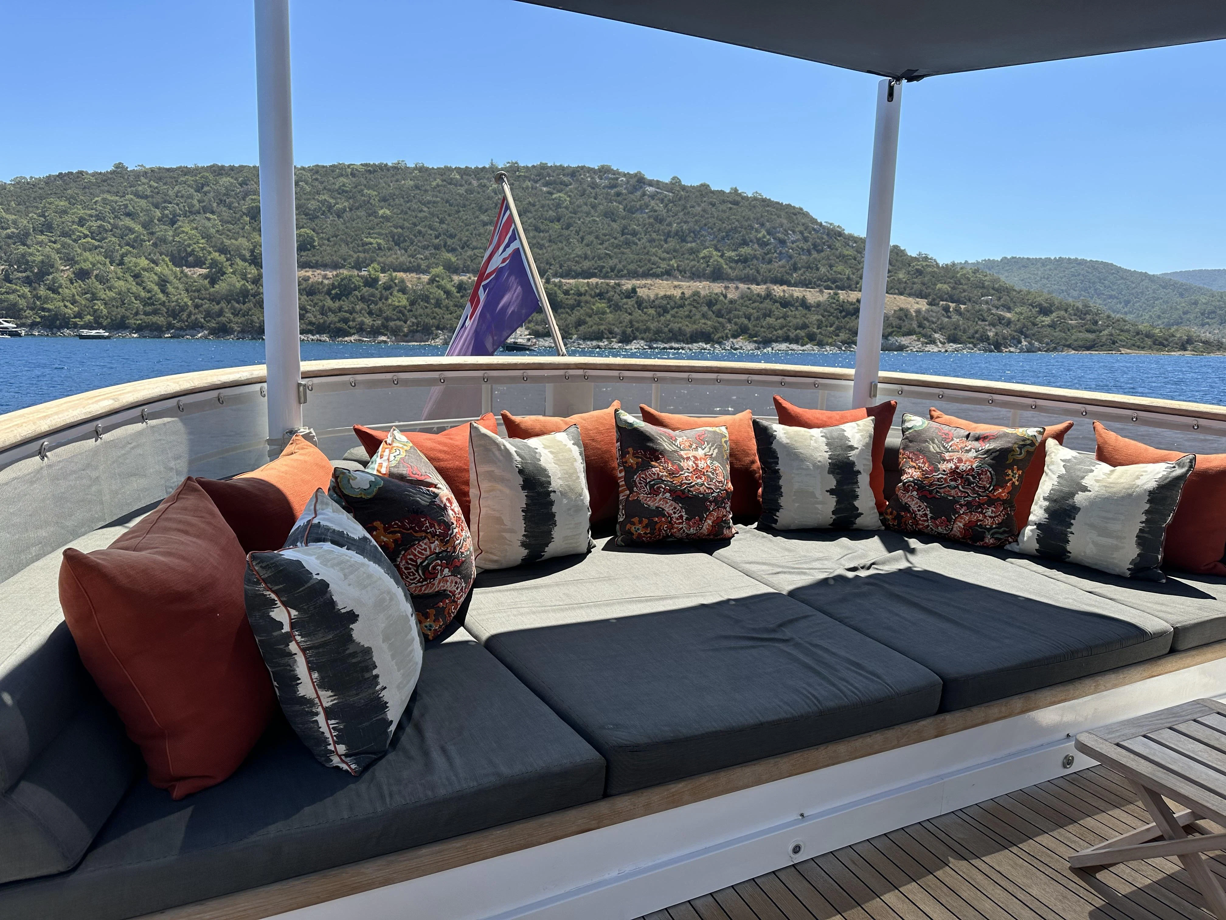 a couch with pillows on it aboard ICE LADY Yacht for Sale