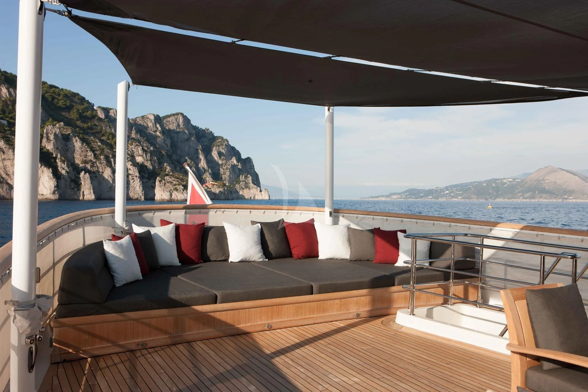 a large bed on a deck overlooking a body of water aboard ICE LADY Yacht for Sale