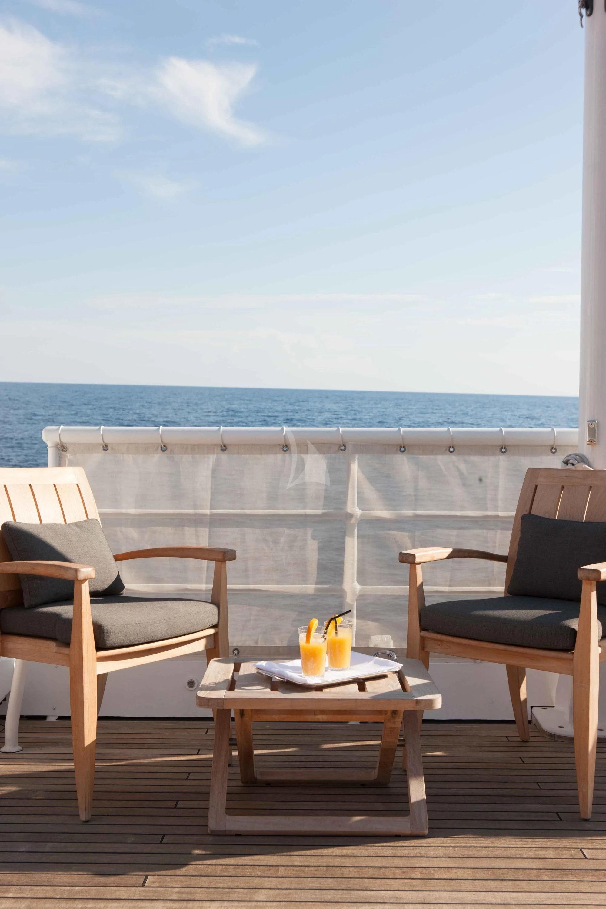 a table and chairs on a deck aboard ICE LADY Yacht for Sale