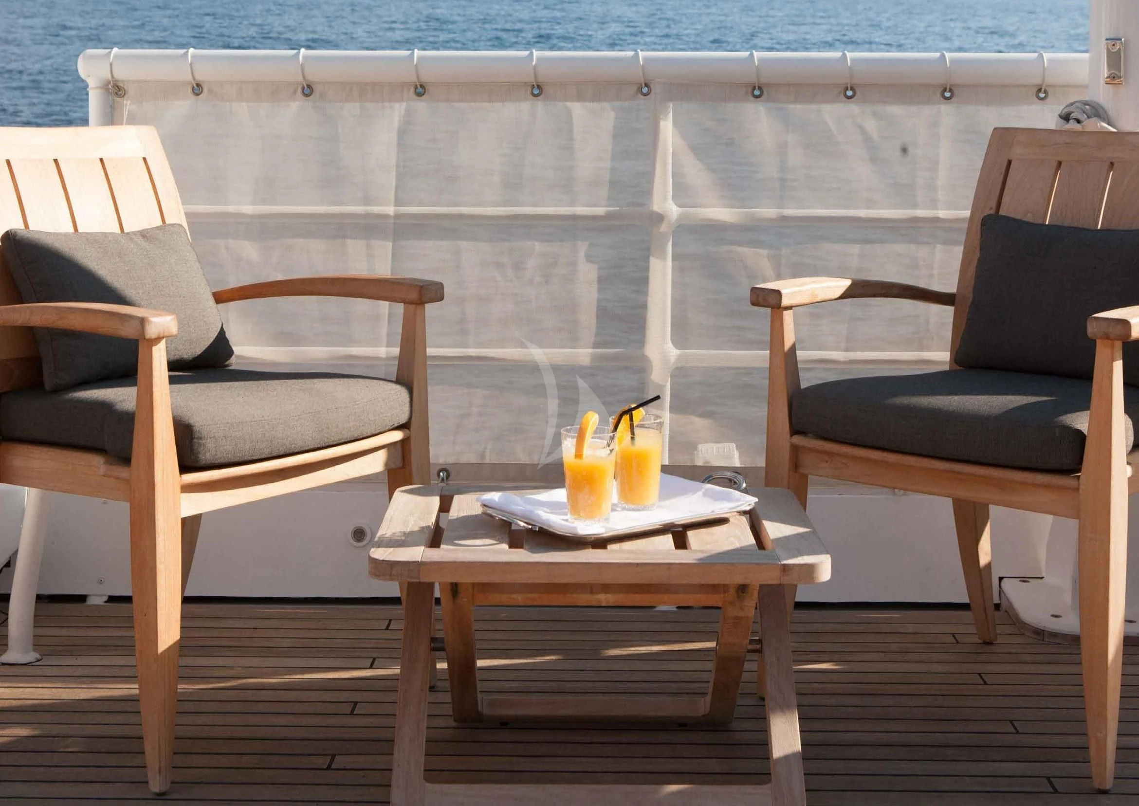 a table and chairs outside aboard ICE LADY Yacht for Sale
