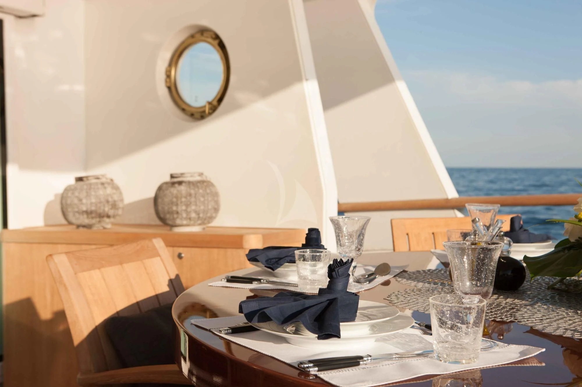 a table with chairs and a window overlooking the ocean aboard ICE LADY Yacht for Sale