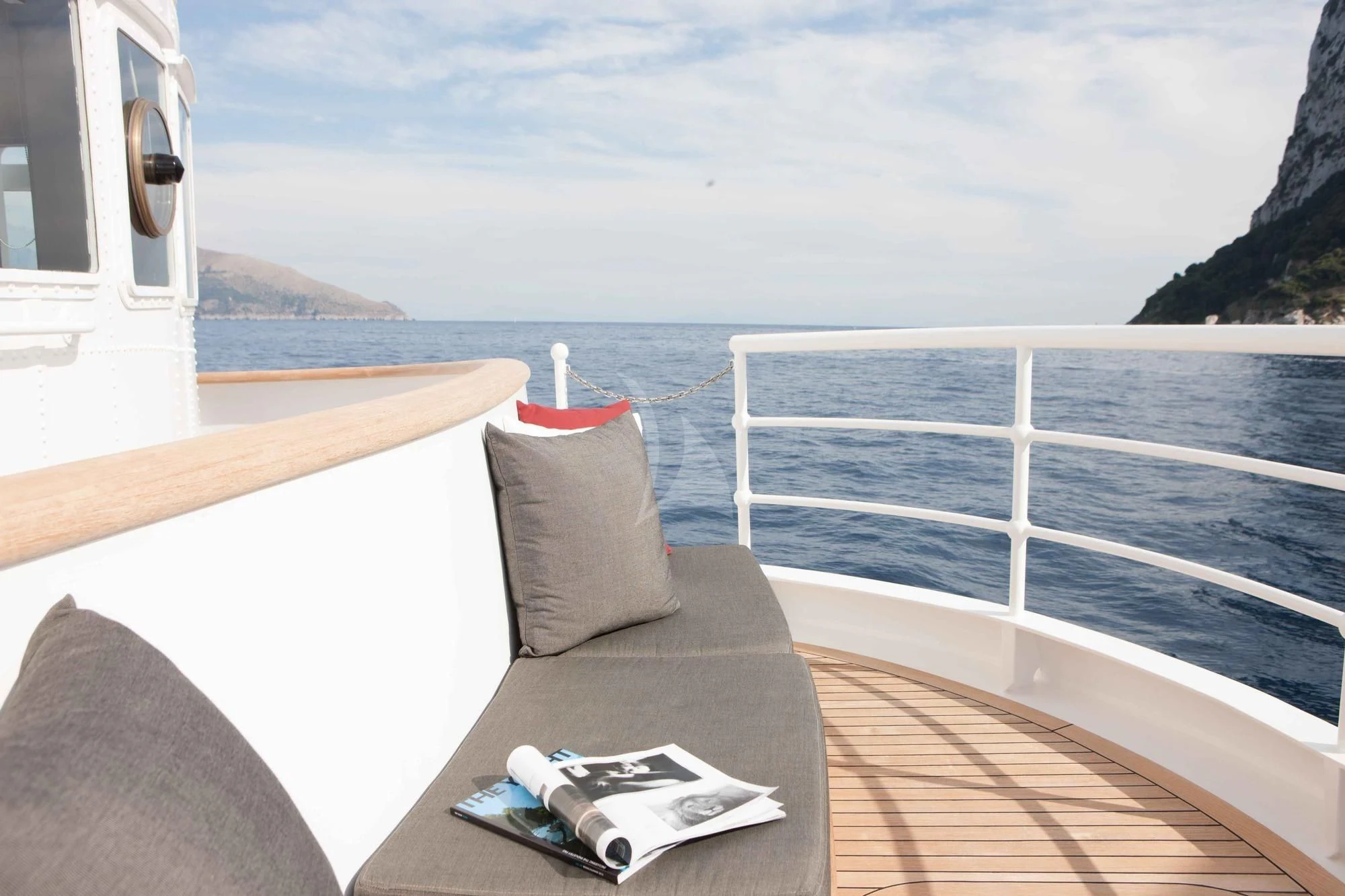 a couch on a deck overlooking the ocean aboard ICE LADY Yacht for Sale