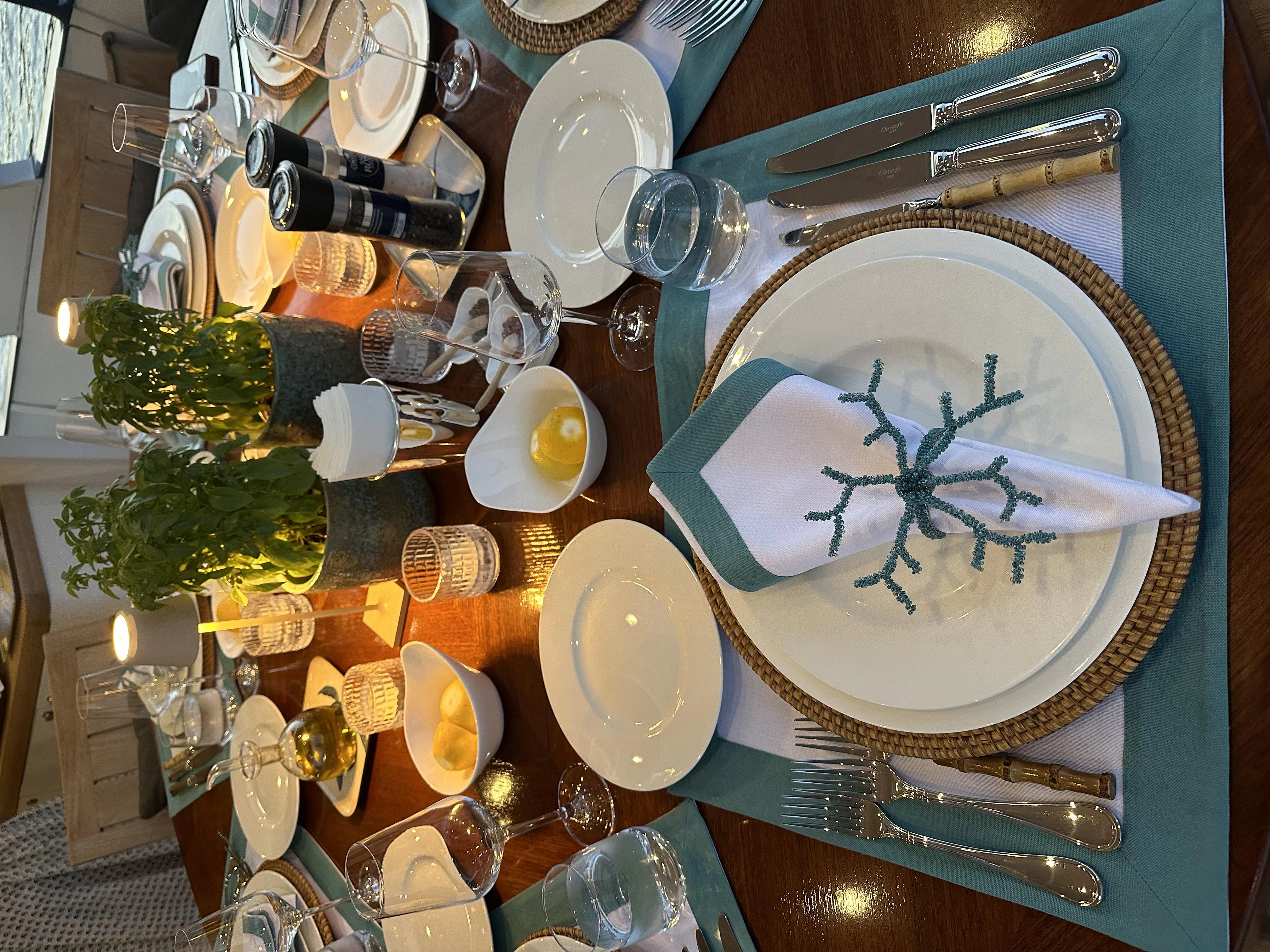 a table with plates and silverware aboard ICE LADY Yacht for Sale