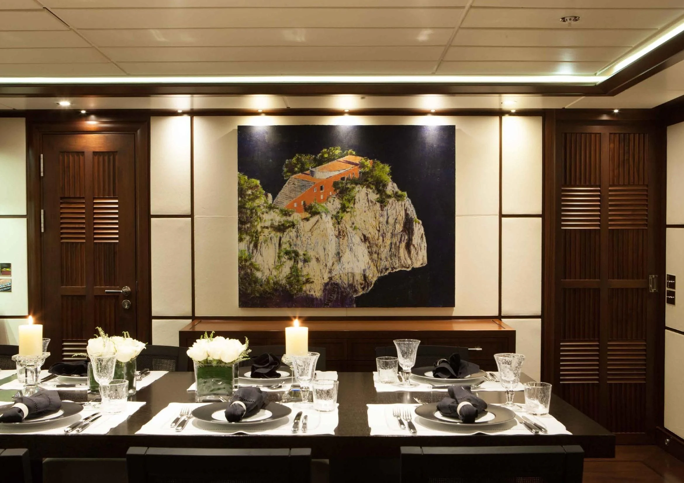 a table with plates and glasses aboard ICE LADY Yacht for Sale