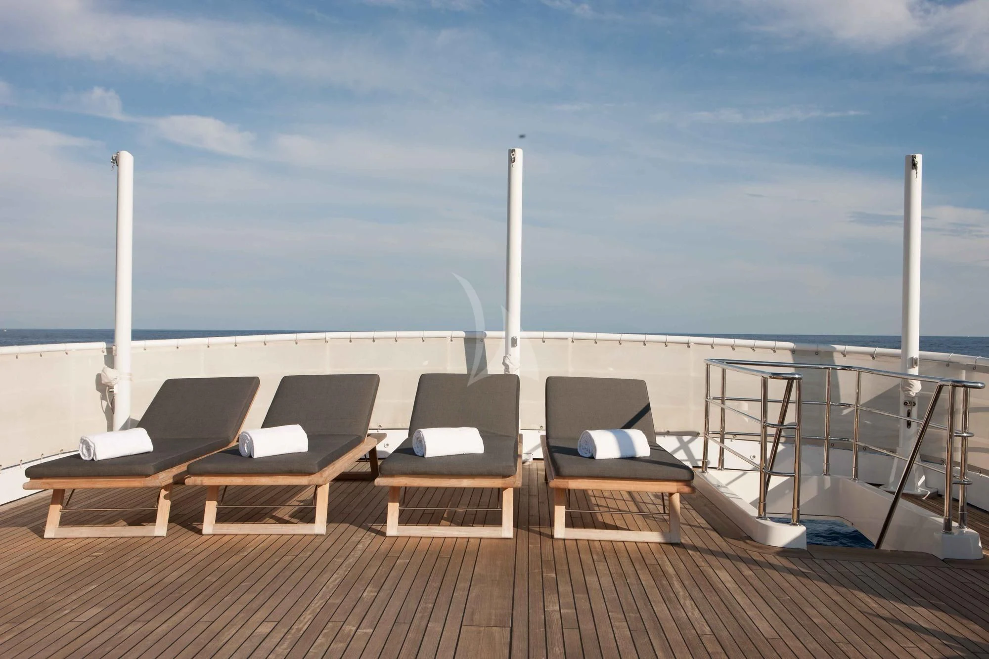 a deck with chairs and a view of the ocean aboard ICE LADY Yacht for Sale