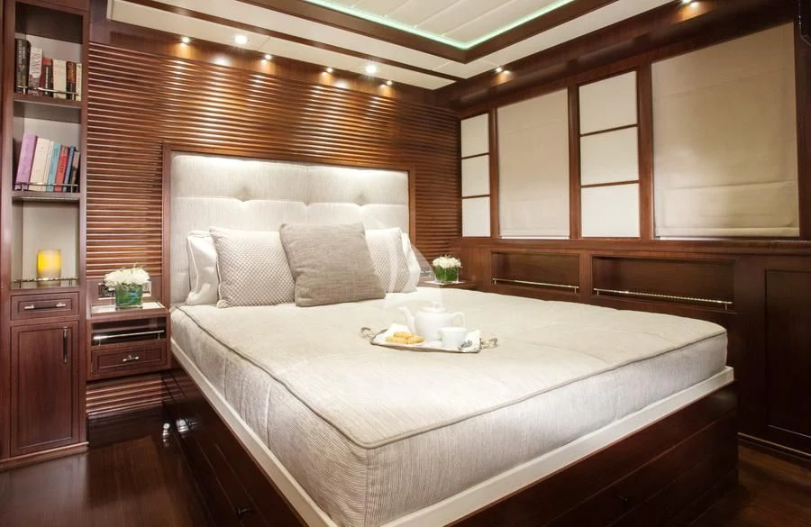 a bed with a white sheet aboard ICE LADY Yacht for Sale