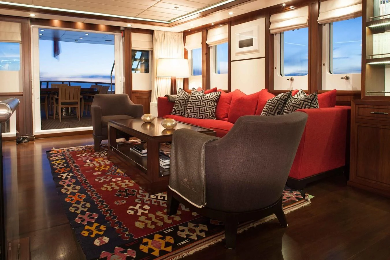 a living room with a red and black rug aboard ICE LADY Yacht for Sale