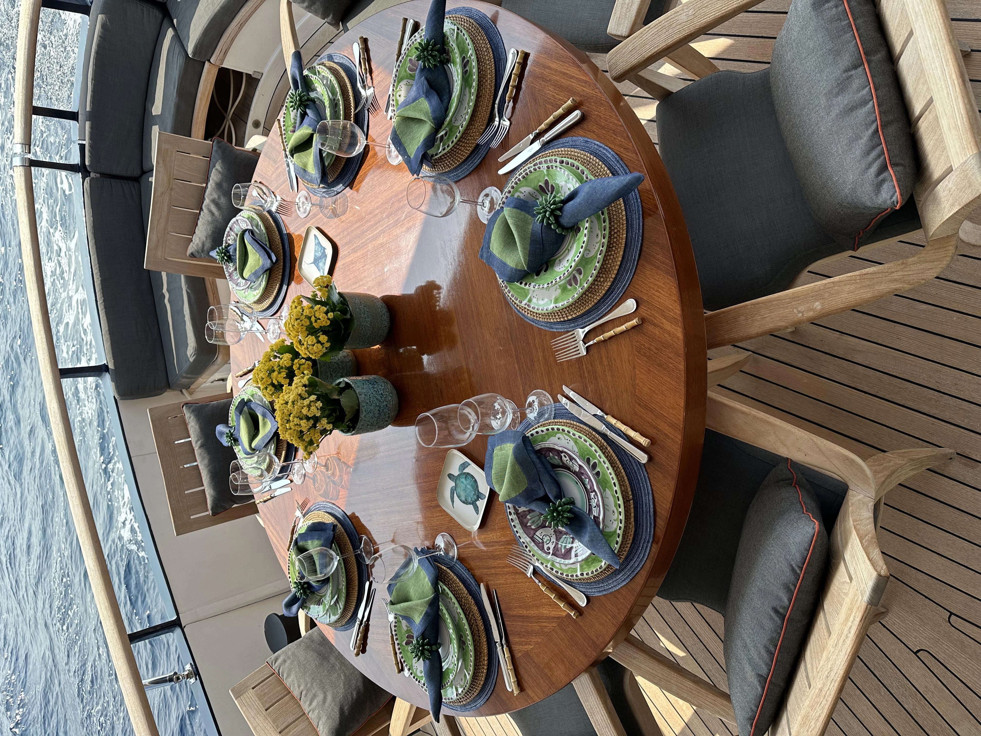 a table with plates and silverware aboard ICE LADY Yacht for Sale