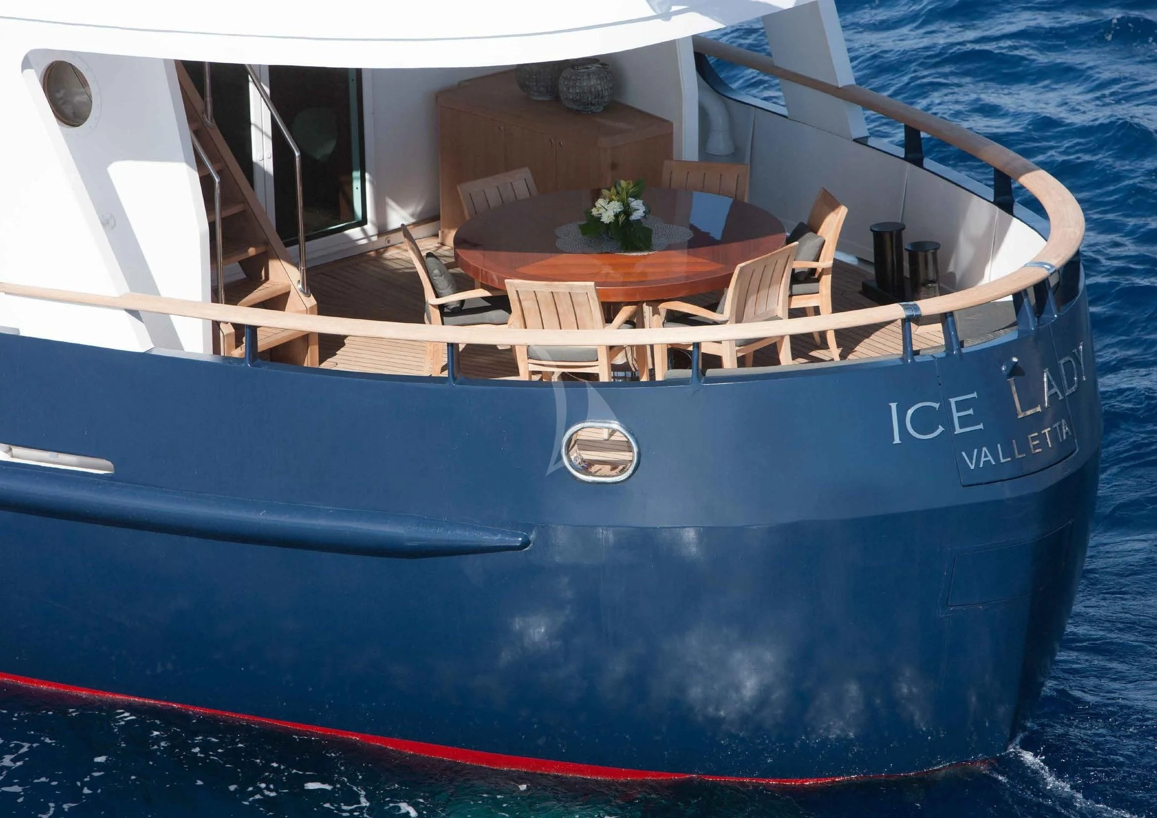 a boat with a table and chairs on the deck aboard ICE LADY Yacht for Sale