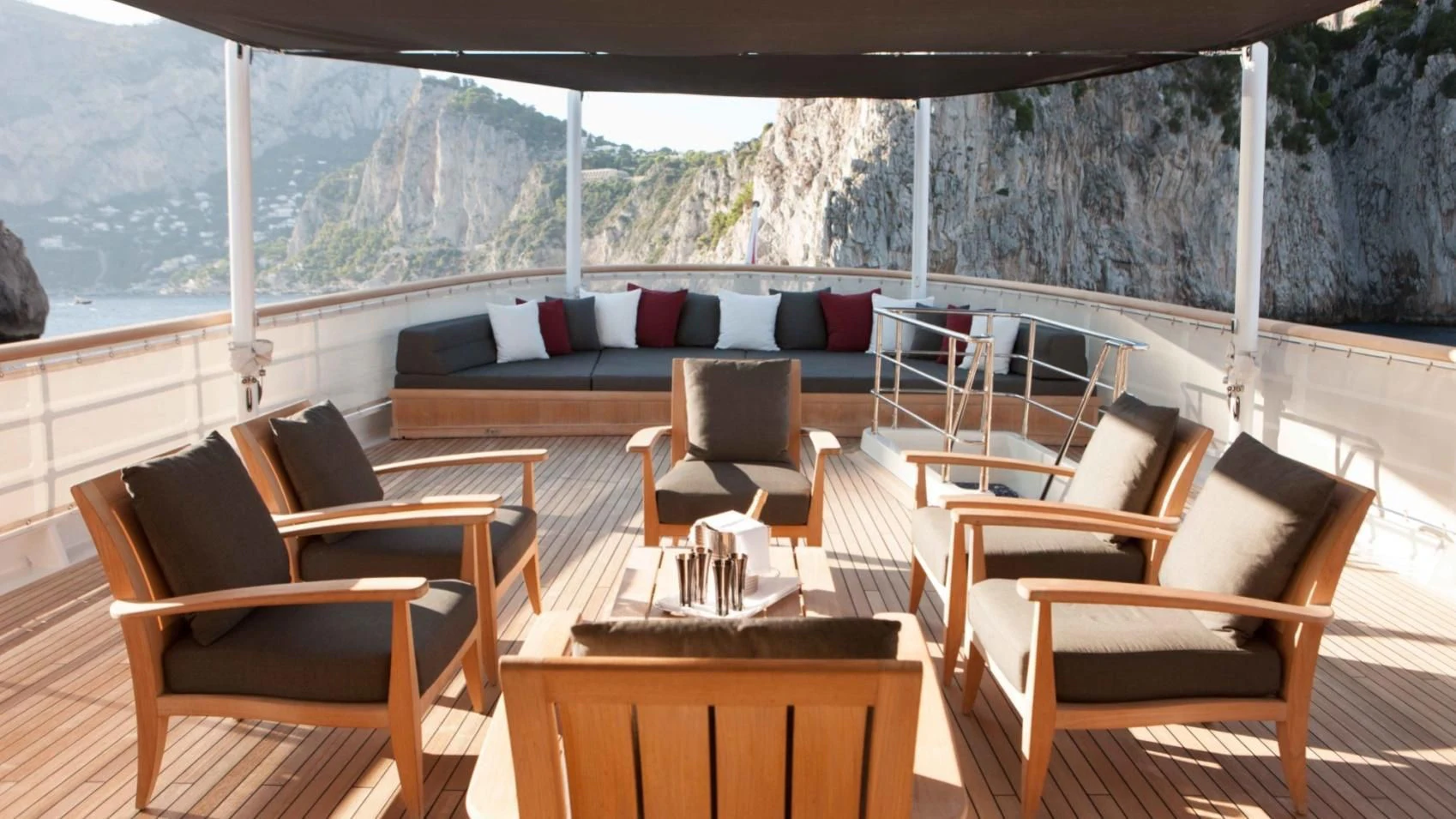 a room with a table chairs and a couch aboard ICE LADY Yacht for Sale
