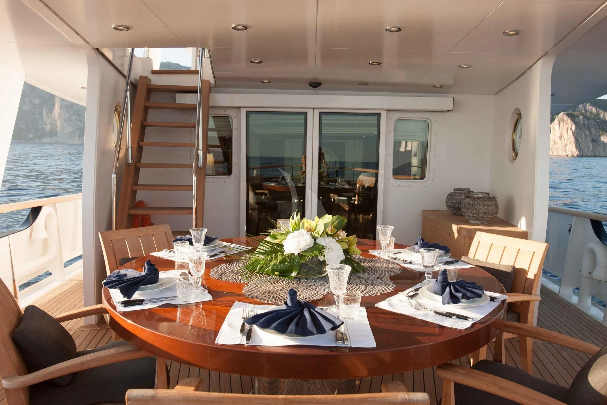 a dining table with chairs and a view of the outside aboard ICE LADY Yacht for Sale