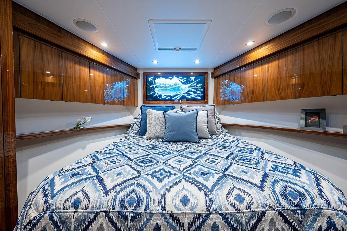 a bed with a blue comforter aboard SURFBUM Yacht for Sale